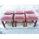 A set of six upholstered hardwood stools with rectangular dished seats on square column legs