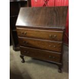 An Edwardian mahogany bureau, the fallfront enclosing a fitted interior with small drawers,