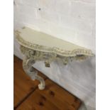 A painted & carved hall table or shelf, the scalloped top above a pierced scrolled frieze having
