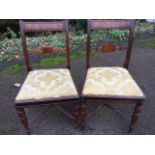 A near pair of nineteenth century mahogany dining chairs with tablet back rails framed by fluted