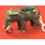 A cold painted bronze elephant with pincushion aperture to back - unmarked. (2.75in)