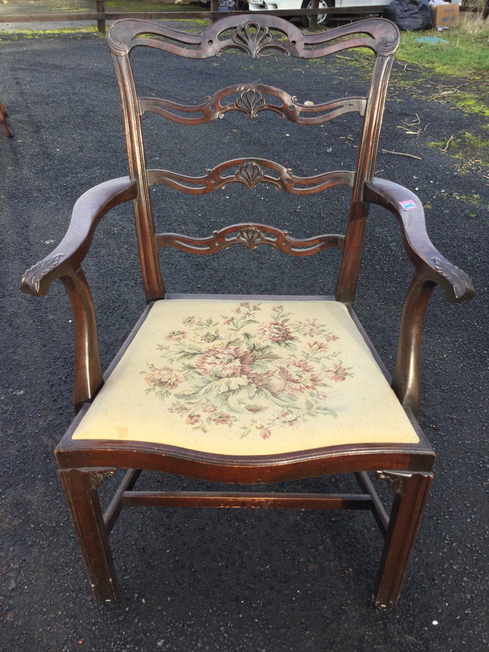 A mahogany ladderback elbow chair with four pierced anthemion carved rails, the shaped arms with