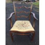 A mahogany ladderback elbow chair with four pierced anthemion carved rails, the shaped arms with