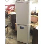 A two-door Indesit fridge freezer. (21in x 23in x 68.5in)