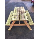 A garden picnic table and bench with slatted rectangular top above two seats on angled supports. (