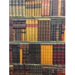 A two section panel of faux leather bound books on four painted shelves. (43in x 57.25in) (2)