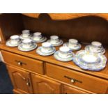 An Aynsley floral teaset decorated with bands of yellow floral sprigs on pale blue ground, with blue