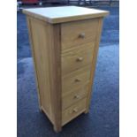 A modern oak chest of five knobbed drawers, with panelled sides. (20in x 17in x 45in)