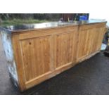 A pine bar unit in two sections, the formica covered moulded top above tongue & grooved panelled