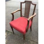 A 19th century mahogany Hepplewhite style elbow chair with moulded back with five spindles, shaped