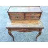 A nineteenth century rosewood desk/games table inlaid with fine brass scrolled decoration with