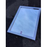 A contemporary mirror in polished chromed metal frame. (21.5in x 29.5in)