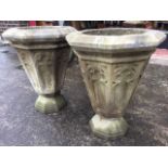 A pair of nineteenth century octagonal carved stone urns, the circular bowls on tapering pots carved