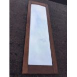 A rectangular oak framed mirror with bevelled plate. (21.5in x 75in ext)
