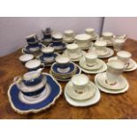 A crown Staffordshire blue, cream and gilt tea set of 10 cups, 12 saucers, 11 side plates, 2 serving