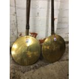 A domed bed warmer with brass hinged lid on a copper bowl and cast iron shaft; a second brass bed