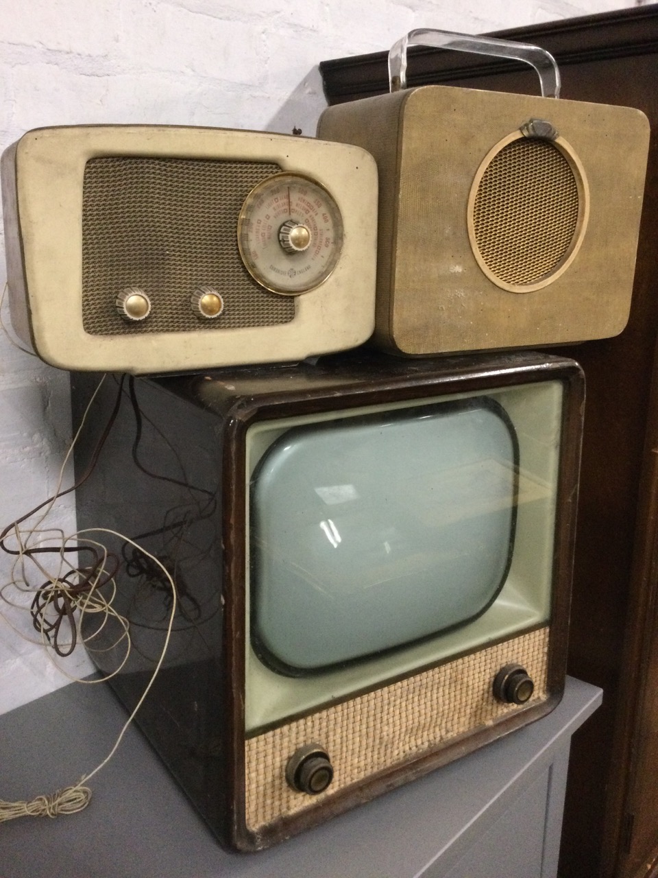 A wood framed 60s television, the screen behind glass with speaker below; a Pye walnut cased valve