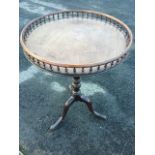 A George II mahogany circular tray-top occasional table, the tip-up top with gallery spindles