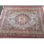 A floral Wilton style wool carpet woven in an orientalist Kashan paisley design having field with