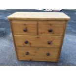 A Victorian pine chest of drawers with rectangular rounded top above two short and two long