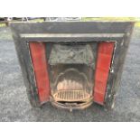 A Victorian cast iron fireplace insert, with moulded frame around tiled panels, the hood with