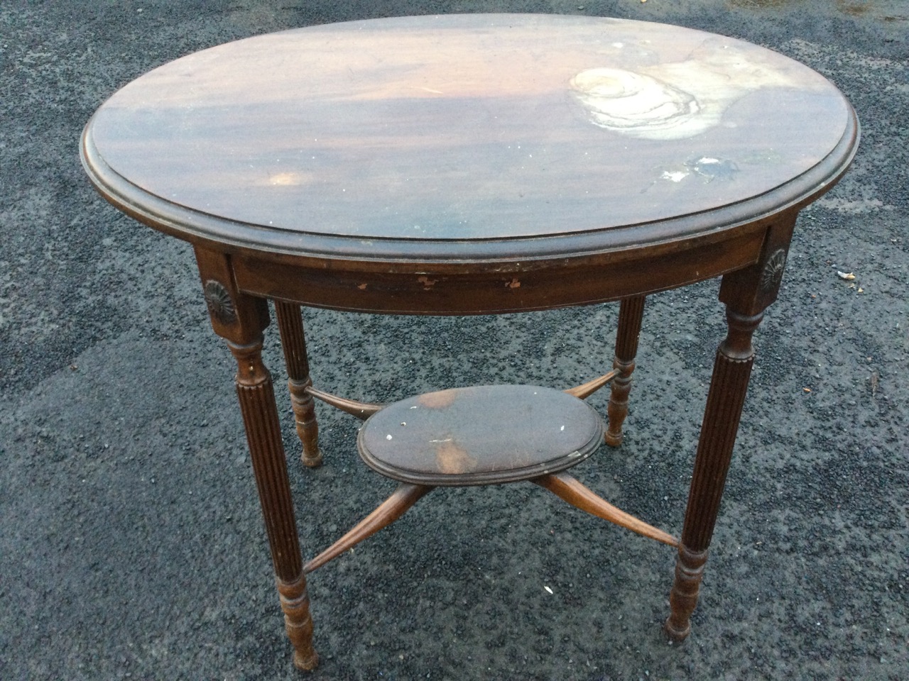 An oval mahogany occasional table, the moulded top on reeded column legs with applied floral - Image 2 of 3