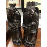 A pair of carved Japanese hardwood bearded deity figures inlaid with bead eyes and wriggled wirework