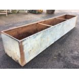 A long rectangular galvanised trough with tubular rim. (96in x 17.5in x 15.75in)