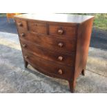 A nineteenth century mahogany bowfronted chest of drawers, with three short and three long boxwood