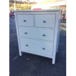 A modern painted chest of two short and two long graduated drawers mounted with metal knobs,
