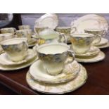 A Paragon 12-piece teaset decorated with woodland scene, sepia transfer printed with yellow,