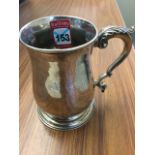 A Georgian hallmarked silver tankard with acanthus leaf scrolled handle, raised on moulded foot -