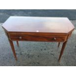 A nineteenth century mahogany boxwood strung turn-over-top tea table with canted corners, having