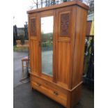 A Victorian satin walnut wardrobe having central bevelled mirror door flanked foliate scroll