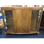 A bowfronted mahogany china cabinet, the moulded top above a central door flanked by astragal glazed