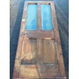 A heavy Edwardian pine bog door from Akeld Station with chamfered panels and glazed upper