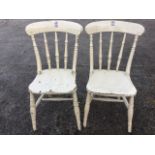 A pair of Victorian painted elm kitchen chairs, the backs with turned spindles above solid seats,