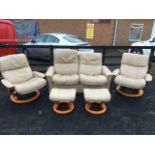 An Ekornes stressless mushroom leather upholstered suite with two armchairs, a two-seater sofa and a