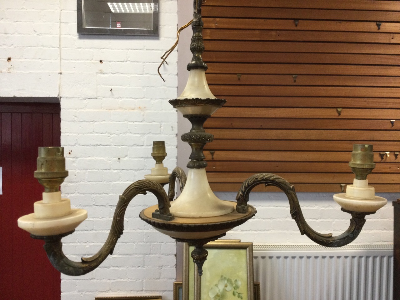 A gilt metal & alabaster chandelier, the column with leaf mounts supported by a chain, the bowl type