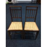 A pair of Edwardian mahogany bedroom chairs, the spindle backs with satinwood banding above