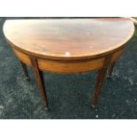 An antique mahogany turn-over-top tea table, the satinwood crossbanded D shaped twin top above a