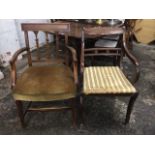 A regency style elbow chair on sabre legs with scroll arms, brass inlaid back bar; another