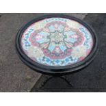 A circular Victorian tray-top beadwork table, the flag style scrolled panel under glass in moulded