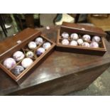 A pair of mahogany cased sets of bluejohn carpet bowls, each rectangular moulded box with