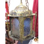 An eastern hexagonal brass & copper hanging lantern, the domed cover with crescent finial