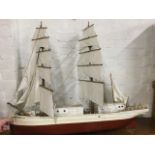 A painted twin-masted model boat, the wide hull with pine deck, cotton sails, cord rigging, etc. (