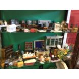 A large collection of dolls house furniture and furnishings including dressers, tables & chairs,
