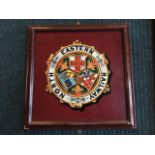 A circular North Eastern Railway coloured medallion having three armorial shields framed by title