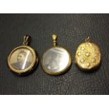 A circular 9ct gold locket with enamelled decoration; a similar circular in 9ct; and another with