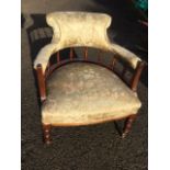 A late Victorian mahogany tub captains style armchair, the upholstered back rail on turned spindles,